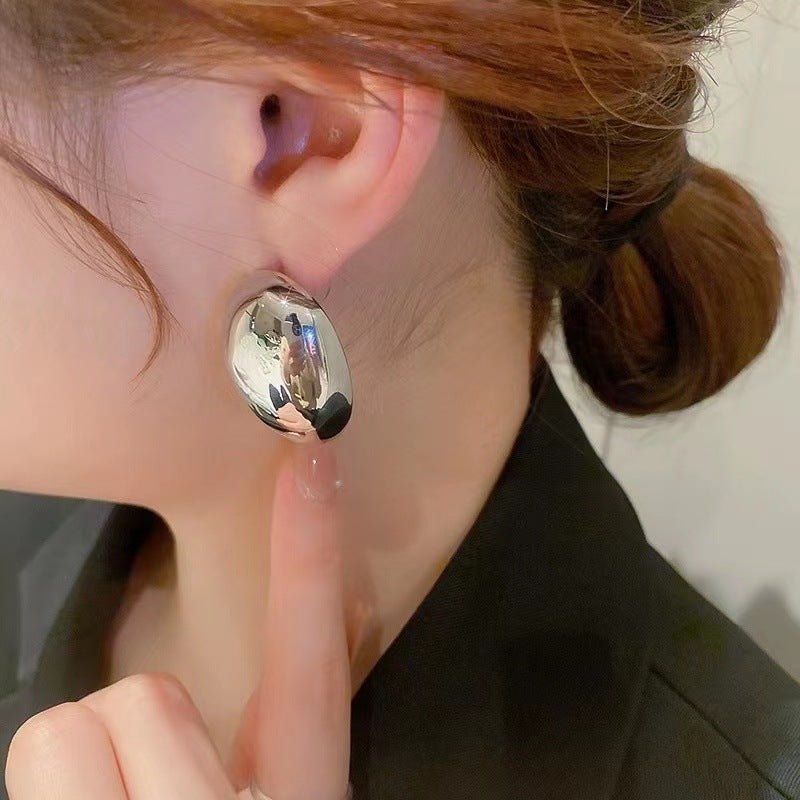 boucle d'oreille argentée sur l'oreille gauche