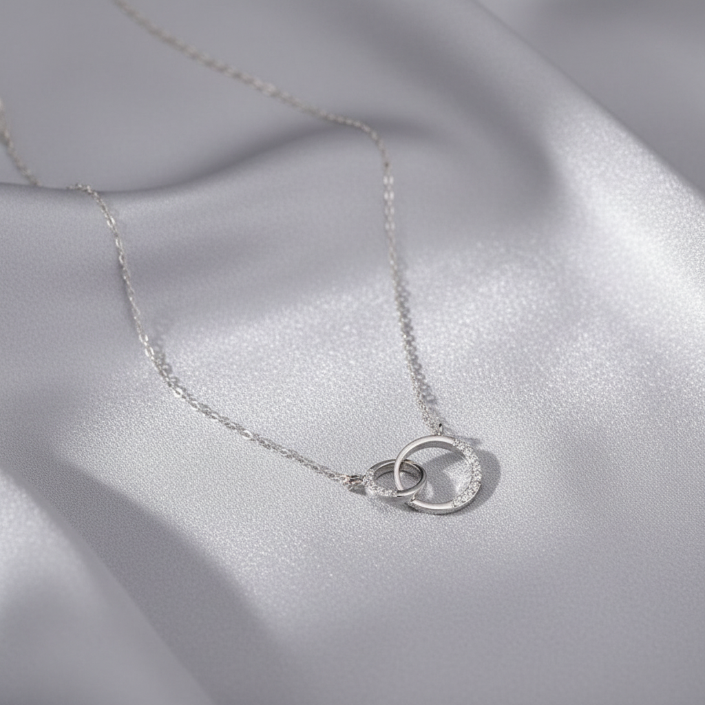 Collier ras de cou Néolune argenté présenté sur une soie grise